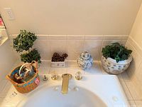 Overview showing basket, topiary, square planter with pinecones, ginger jar, round planter with faux ivy