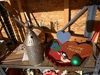Shelf view showing lantern, wall clock, sign, tray, ornament