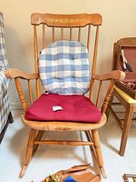 Front view of wooden rocking chair with both cushions