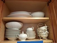 Cabinet view showing full set on two shelves