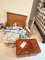 Overall view of sewing boxes, organisers and cardboard box on floor