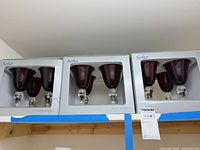 Three Soho boxes each showing burgundy goblets