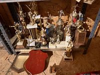 Shelf with assorted trophies and plaque