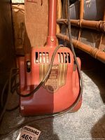 Front view of red Johnson's Wax Electric Floor Polisher showing decal and power cord