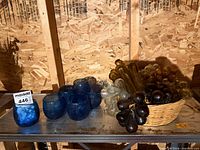 Overall lot showing blue glass holders and basket of glass grape clusters