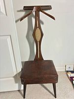 Full view of wood valet chair with seat and hanger arms