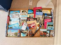 Tray overview showing postcards, booklets, souvenirs