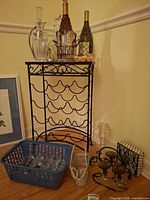 Overall lot with wine rack, bottles, decanters, glassware, corks