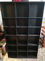 Front view of black 20-cubby bookcase showing cubby grid
