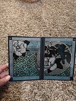 Full view of bifold tabletop panel opened showing both illustrated panels