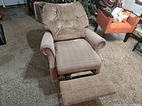 Front view of La-Z-Boy plaid rocker recliner with footrest extended