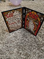 Full view of folding diptych plaque standing open showing both panels