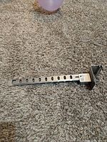 Folding clothes hanger arm extended showing slotted design