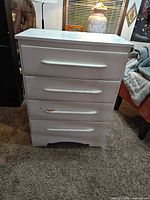 Front view showing four drawers and wear