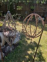 Both beaded metal hanging ornaments suspended outdoors