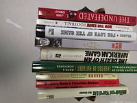 Stack of nine football books showing spines