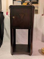 Full view of cabinet showing overall design, door, open shelf and rounded corners