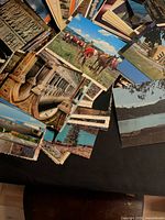 Pile of various scenic and architectural postcards with scalloped edges
