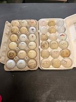 Two cartons holding 36 golf balls of assorted brands