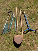 Group shot of all six gardening tools laid on grass