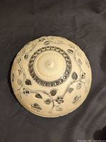 Top view of ivory Art Deco glass ceiling shade with vine relief and chain holes