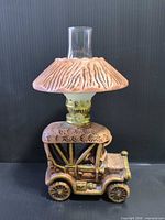 Full view of ceramic truck oil lamp with shade and chimney