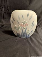 Oval vase front showing raised iris design