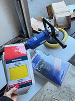 Polisher with yellow pad and two Simoniz bonnet packs
