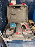 Open case displaying Arrow CT50 staple gun, staple box and grey plastic spool