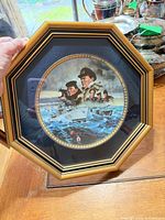 Full view of octagonal framed plate on wooden surface