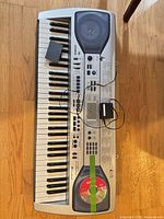 Full view of keyboard with adapter, CD, battery cover