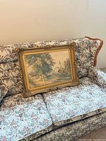 Framed landscape print on sofa showing full frame and artwork