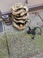 Fountain, owl statue and cat stake on patio