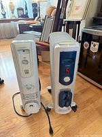 Front view of both heaters showing brands, controls and power cords