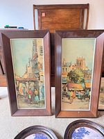 Two vertical framed landscape prints with partial view of two oval rococo prints and one horizontal print