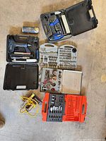 Overview of all tools, cases, bits and cord on floor