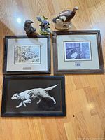 overview showing three framed prints and three figurines