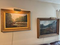 Both landscape paintings on wall with lights
