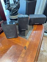 Front view of three Panasonic surround speakers on table