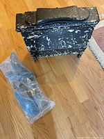 wooden shoe shine box with chippy black paint and sealed shoe stretcher