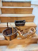 Three wicker baskets displayed on stairs