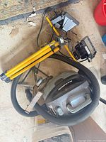 Shop vacuum, construction light stand, scissor jack grouped together