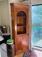 Full front view of wooden corner display cabinet