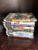 Stack of six PS2 game cases showing titles