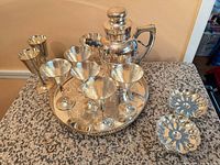 entire twelve-piece hammered silverplate bar set displayed on counter