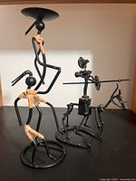 Both metal sculptures side by side for scale and comparison