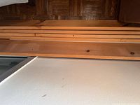 stacked wood shelf boards showing length and finish