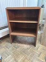 Front view showing two interior shelves and overall structure