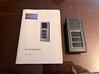 Remote and user guide arranged on table