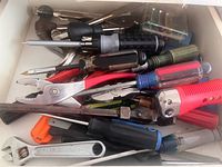 Drawer with pliers, screwdrivers, wrench